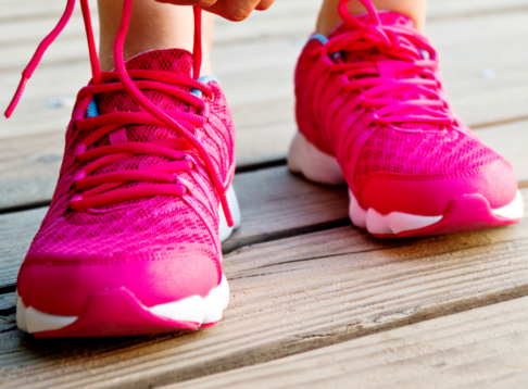 pink shoes being tied on wooden floor